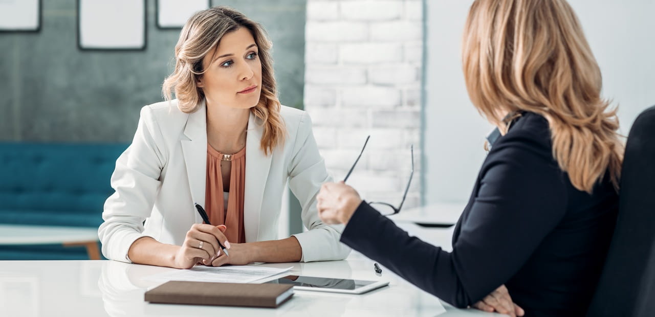 Business owner conducting an exit interview with an employee to uncover workplace insights, improve retention strategies and identify opportunities for organizational growth.