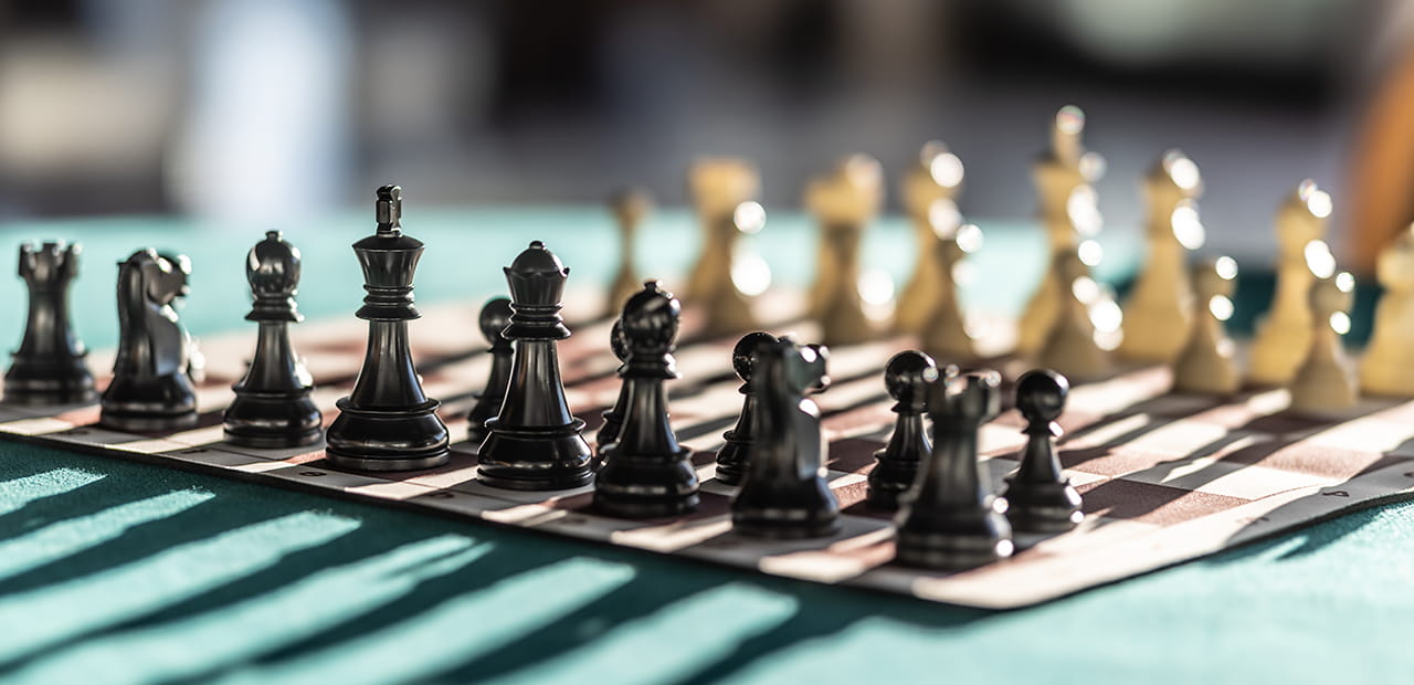 Chess pieces arranged strategically on a board, symbolizing smart planning and practical ways business owners can maximize their time.